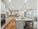 Spacious kitchen showcasing a large center island with seating, white cabinets and stainless steel appliances at 4527 Waylon Ave, Fort Mill, SC 29715