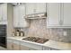 Close-up of kitchen features, showcasing the range, stylish backsplash and abundant counter space at 4527 Waylon Ave, Fort Mill, SC 29715