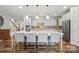 Bright kitchen with white cabinets, a large island, and modern fixtures provides a perfect cooking and gathering space at 4527 Waylon Ave, Fort Mill, SC 29715