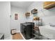 Modern laundry room equipped with new washer and dryer, shelving, and a utility sink at 4527 Waylon Ave, Fort Mill, SC 29715