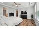 Bright main bedroom with wood floors, ceiling fan, and black dresser at 4527 Waylon Ave, Fort Mill, SC 29715