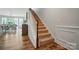 Carpeted staircase with wooden banister and trim, leading to the upper level of the home at 4527 Waylon Ave, Fort Mill, SC 29715