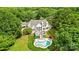 Aerial view of a luxurious home with a backyard pool and patio, surrounded by mature trees at 469 Valley Run Dr, Waxhaw, NC 28173
