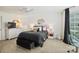Modern bedroom with neutral colors, ceiling fan, and sitting area near bright windows at 469 Valley Run Dr, Waxhaw, NC 28173