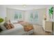 Bright bedroom with two twin beds, sunny windows, and access to private balcony at 469 Valley Run Dr, Waxhaw, NC 28173