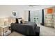 Modern bedroom with neutral colors, ceiling fan, and sitting area near bright bay windows at 469 Valley Run Dr, Waxhaw, NC 28173