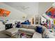This bonus room has a large sectional sofa, a bedroom area, decor, and natural light from the skylights at 469 Valley Run Dr, Waxhaw, NC 28173