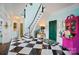 Elegant foyer with a curved staircase, black and white tiled floors, and bright, colorful accents at 469 Valley Run Dr, Waxhaw, NC 28173