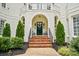 Inviting front entrance with brick steps, a decorative wreath, and professionally landscaped surroundings at 469 Valley Run Dr, Waxhaw, NC 28173