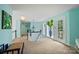 Light-filled upstairs hallway featuring a curved staircase, light blue walls, and an oversized vase at 469 Valley Run Dr, Waxhaw, NC 28173