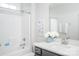 Bright bathroom with white tile, gray vanity, and modern fixtures at 5107 Raging Creek Dr, Indian Trail, NC 28079