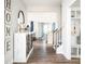 Welcoming entryway with wood floors, console table, and staircase at 5107 Raging Creek Dr, Indian Trail, NC 28079