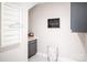Well-lit laundry room with built in storage and modern decor at 5107 Raging Creek Dr, Indian Trail, NC 28079