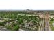 A high-angle view displays neighborhood homes, trees, railroad tracks, and Charlotte's skyline in the distance at 511 Donatello Ave, Charlotte, NC 28205