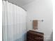 Bright bathroom featuring curtained shower and a woven hamper at 511 Donatello Ave, Charlotte, NC 28205