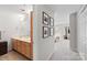 Bright bathroom showcasing a double sink vanity, tile flooring and access to bedroom at 511 Donatello Ave, Charlotte, NC 28205