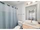 This bright bathroom features a vanity with storage, a large mirror, and a shower-tub with a stylish blue curtain at 511 Donatello Ave, Charlotte, NC 28205