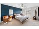 Modern bedroom featuring an accent wall, fan, and a comfortable leather chair at 511 Donatello Ave, Charlotte, NC 28205