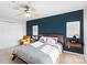 Comfortable bedroom featuring an accent wall, fan, and soft natural lighting at 511 Donatello Ave, Charlotte, NC 28205