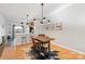 Open dining area with a modern light fixture and an adjacent breakfast bar at 511 Donatello Ave, Charlotte, NC 28205