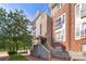 Beautiful townhome exterior with a well-maintained brick walkway and lush green trees at 511 Donatello Ave, Charlotte, NC 28205