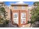 A charming brick townhouse with multi-level balconies on a sunny day at 511 Donatello Ave, Charlotte, NC 28205