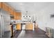 Well-lit kitchen with stainless steel appliances, wood cabinets, and gray tiled floors at 511 Donatello Ave, Charlotte, NC 28205