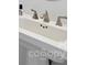 Close-up of a ceramic sink basin with bronze fixtures at 511 Donatello Ave, Charlotte, NC 28205
