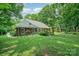 Well-maintained brick home with a neatly landscaped backyard and mature trees providing a serene environment at 5208 Black Oak Ln, Waxhaw, NC 28173