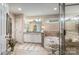 Bright bathroom boasts a large soaking tub, double vanity, granite counters, and tile floors at 5208 Black Oak Ln, Waxhaw, NC 28173