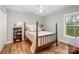 Cozy bedroom boasts hardwood floors, a ceiling fan, and a backyard view at 5208 Black Oak Ln, Waxhaw, NC 28173