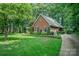 Well-maintained brick home with lush greenery, a neatly manicured lawn, and a paved driveway at 5208 Black Oak Ln, Waxhaw, NC 28173