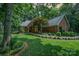 Charming brick home with manicured lawn, lush landscaping, and inviting curb appeal on a sunny day at 5208 Black Oak Ln, Waxhaw, NC 28173