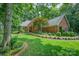 Charming brick home with manicured lawn, lush landscaping, and inviting curb appeal on a sunny day at 5208 Black Oak Ln, Waxhaw, NC 28173