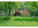 Beautiful brick home with well-manicured lawn and lush landscaping, showcasing curb appeal at 5208 Black Oak Ln, Waxhaw, NC 28173