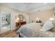 Cozy main bedroom featuring hardwood floors, soft lighting, and adjacent bathroom access at 5208 Black Oak Ln, Waxhaw, NC 28173