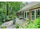 Charming outdoor patio area with stone flooring, perfect for entertaining and relaxation surrounded by lush landscaping at 5208 Black Oak Ln, Waxhaw, NC 28173