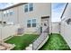 Backyard patio area featuring a staircase, privacy fence and artificial turf at 5391 Orchid Bloom Dr, Fort Mill, SC 29707
