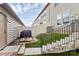 A backyard with an artificial lawn, stone landscaping, stairs to the patio with furniture at 5391 Orchid Bloom Dr, Fort Mill, SC 29707