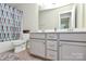 Bathroom with a double vanity and bathtub with colorful shower curtain at 5391 Orchid Bloom Dr, Fort Mill, SC 29707