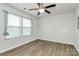 Bedroom with light hardwood floors, and multiple windows at 5391 Orchid Bloom Dr, Fort Mill, SC 29707