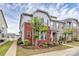 Charming townhome showcasing brick accents, complemented by a well-manicured lawn and lush landscaping at 5391 Orchid Bloom Dr, Fort Mill, SC 29707