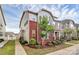 Charming townhome showcasing brick accents, complemented by a well-manicured lawn and lush landscaping at 5391 Orchid Bloom Dr, Fort Mill, SC 29707