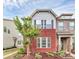 Charming townhome showcasing brick accents, complemented by a well-manicured lawn and lush landscaping at 5391 Orchid Bloom Dr, Fort Mill, SC 29707