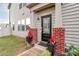 A welcoming front entryway featuring a decorative glass door, brick columns, and charming flower pots at 5391 Orchid Bloom Dr, Fort Mill, SC 29707