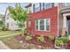 Up close front brick facade, lush landscaping, and healthy lawn at 5391 Orchid Bloom Dr, Fort Mill, SC 29707