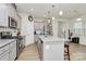 Modern kitchen features stainless steel appliances, granite countertops, and a central island at 5391 Orchid Bloom Dr, Fort Mill, SC 29707