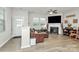 Bright living room with luxury vinyl flooring, a cozy fireplace, and a comfy leather sectional at 5391 Orchid Bloom Dr, Fort Mill, SC 29707