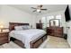 Spacious bedroom features a ceiling fan, lots of natural light, and a full set of wooden bedroom furniture at 5391 Orchid Bloom Dr, Fort Mill, SC 29707