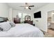 Bright bedroom with ceiling fan, a TV, natural light and a view of a bathroom at 5391 Orchid Bloom Dr, Fort Mill, SC 29707